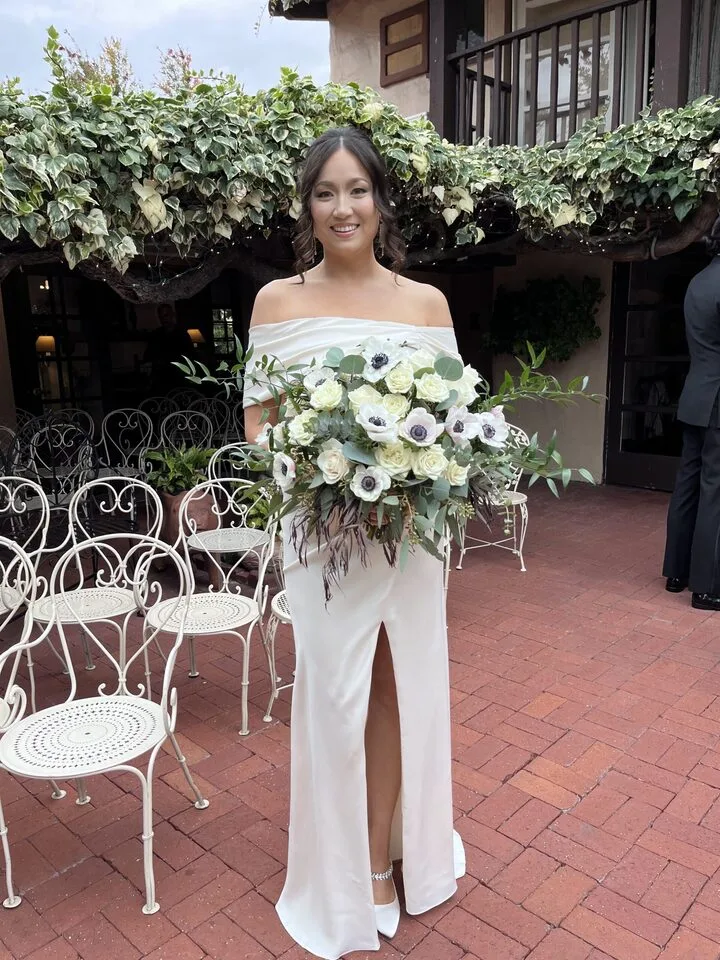 Bride carrying an elegant white bouquet