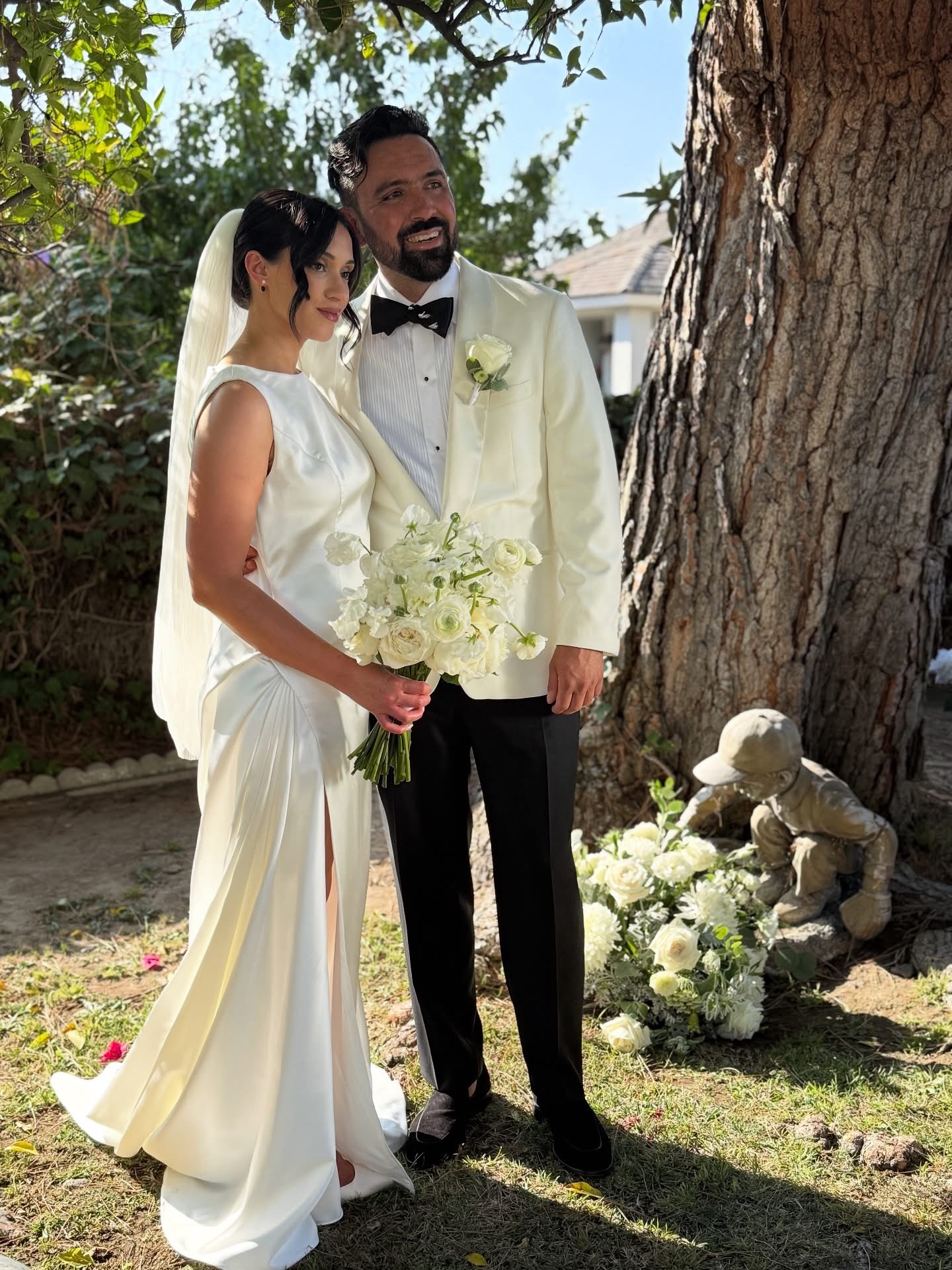 Bride and groom beneath a tree