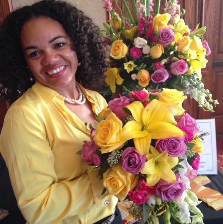 Josy holding a vibrant floral arrangement