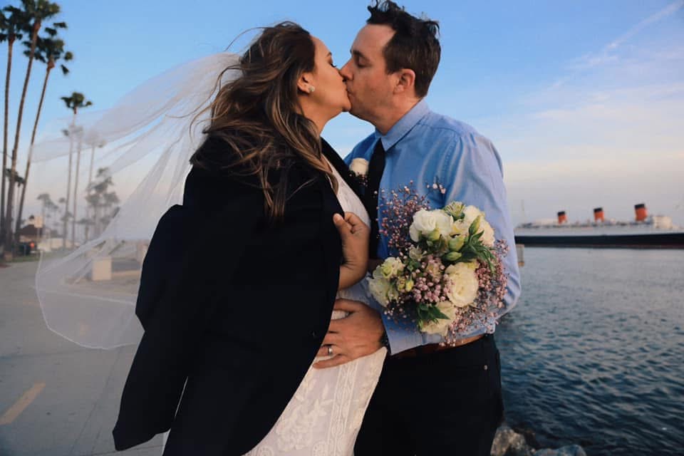 Newlywed couple by the waterfront